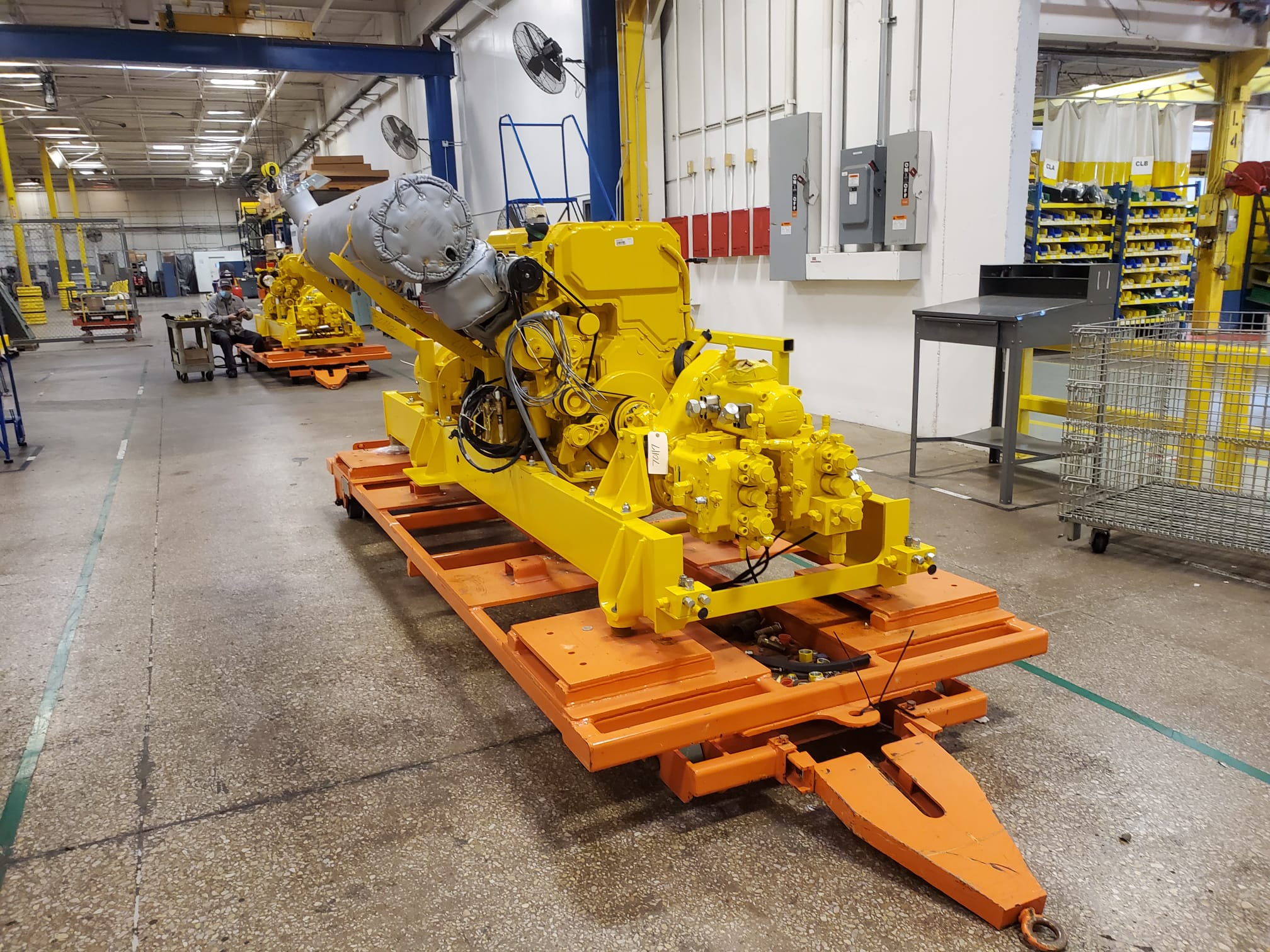 Mining technician inspecting replacement parts for heavy equipment at an industrial mining operation.