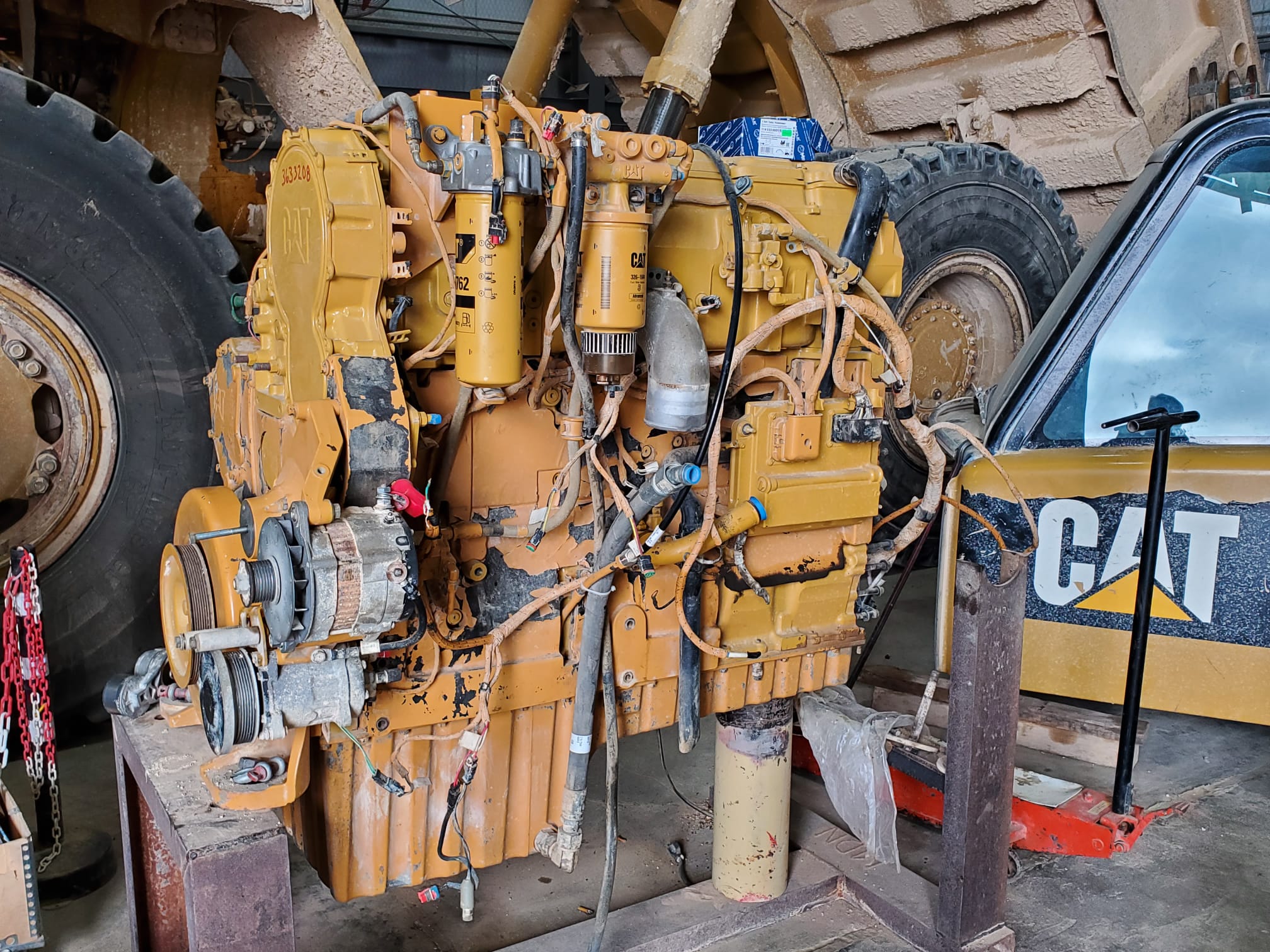 Technician inspecting remanufactured mining equipment parts to verify condition, fitment, and reliability before installation.