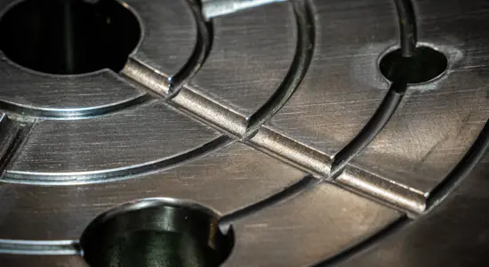 Worn crusher wear parts laid out for inspection and replacement in a heavy industrial crushing operation