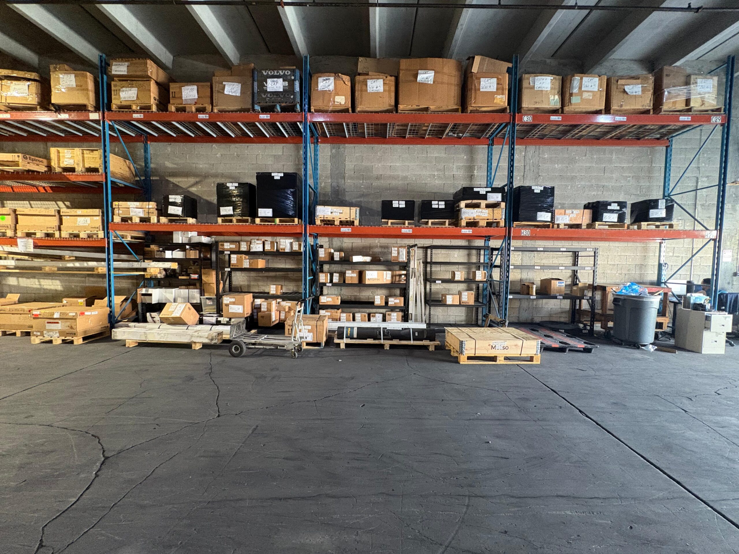 Mining replacement parts being verified against machine serial numbers at a Miami warehouse before shipment to the Caribbean and South America
