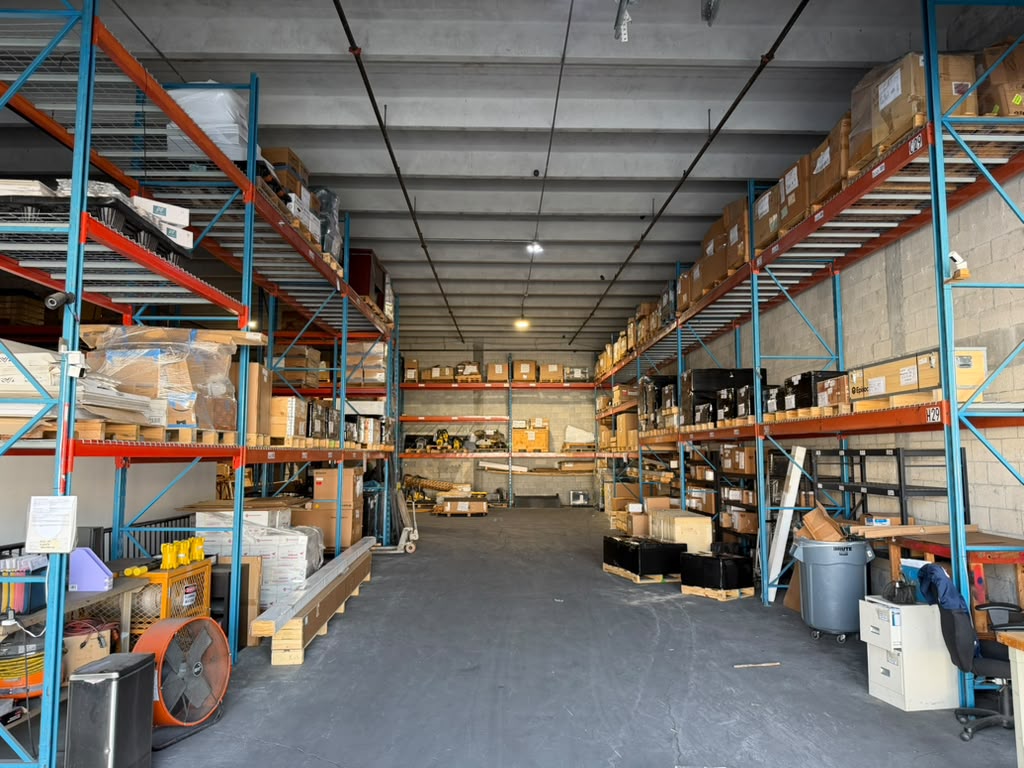 Industrial machinery parts being verified against serial number documentation at Millennium Machinery Miami warehouse before cross-border shipment to the Caribbean